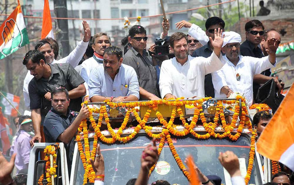 Congress Vice President Rahul Gandhi waves to the crowd at a road show with party candidate Ajay Rai in Varanasi.