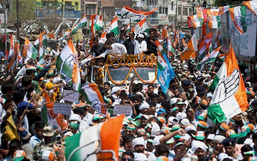 Congress Vice President Rahul Gandhi shakes hands with supporters during a road show for party candidate Ajay Rai in Varanasi.