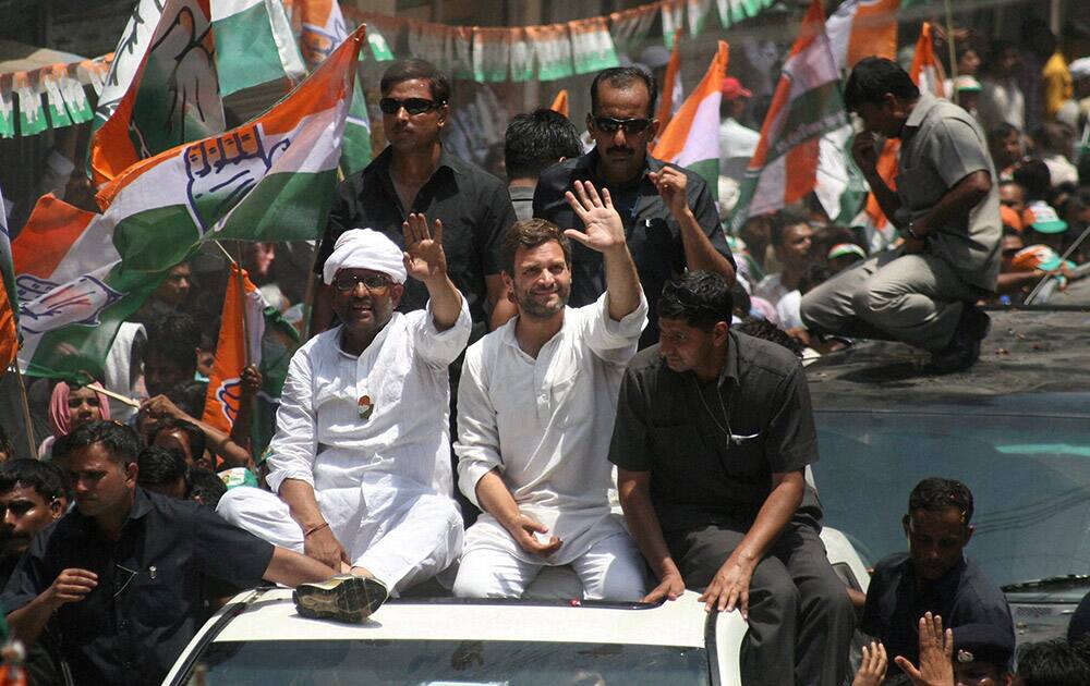 Congress Vice President Rahul Gandhi waves to the crowd at a road show with party candidate Ajay Rai in Varanasi.