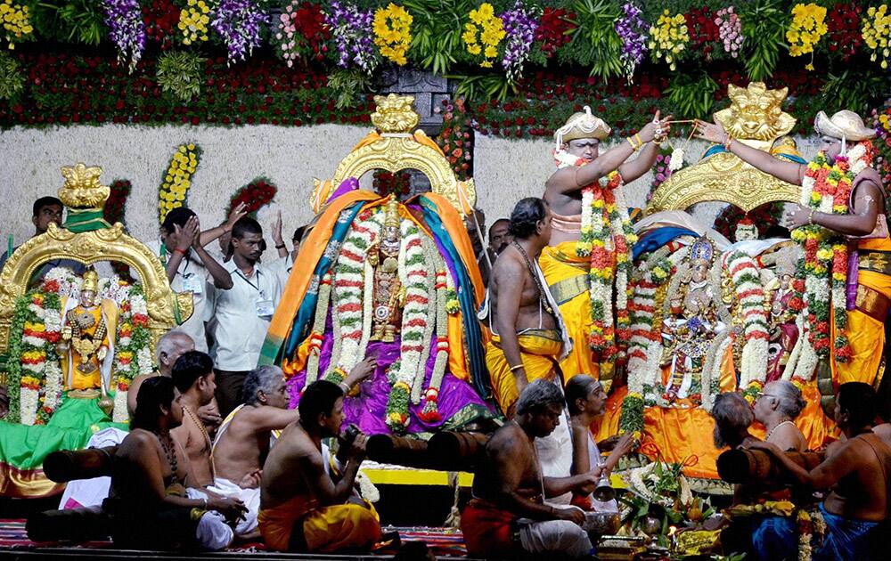 Priests perform the celestial wedding of Goddess Meenakshi with Lord Sundareswarar on the 10th day of Chithrai festival at Meenakshi Amman Temple in Madurai.