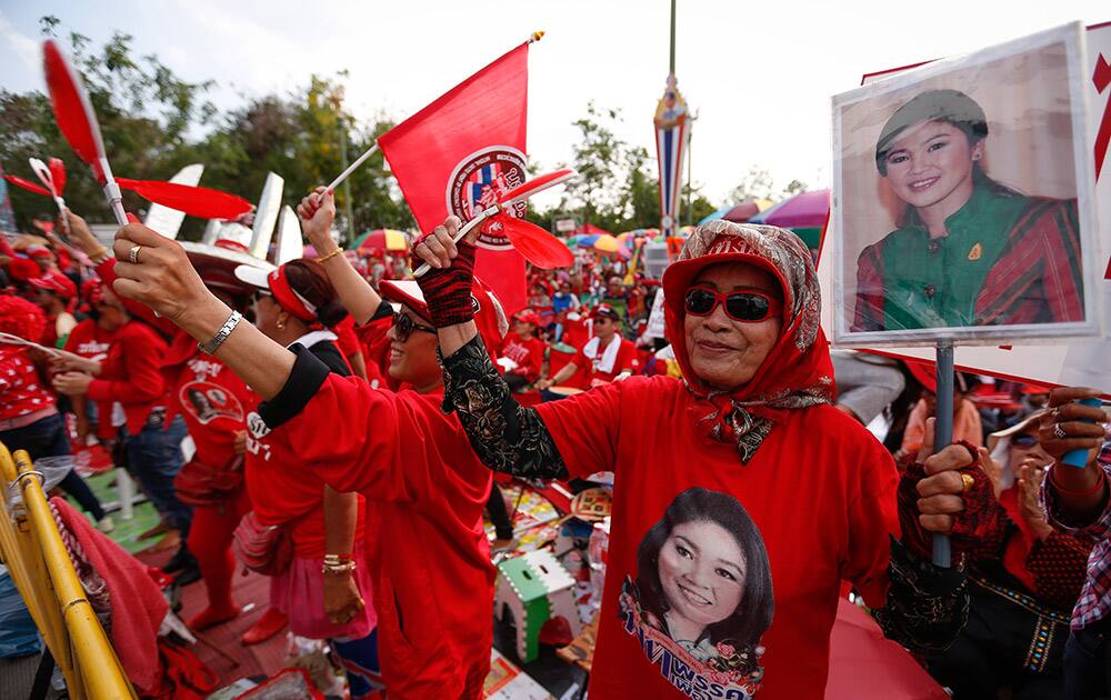 Pro-government protesters wave flags during a rally in Aksa, outskirt of Bangkok, Thailand.