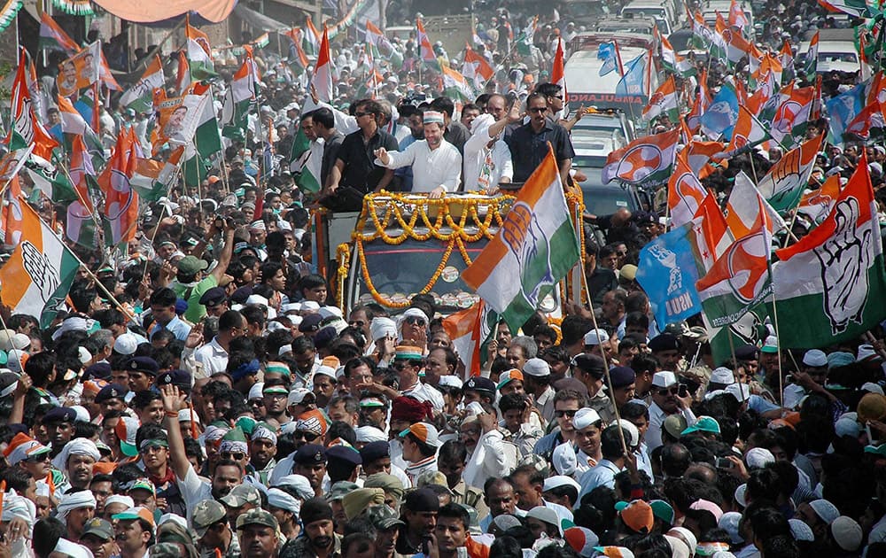 Congress Vice President Rahul Gandhi with party candidate Ajay Rai during an election road show in Varanasi.