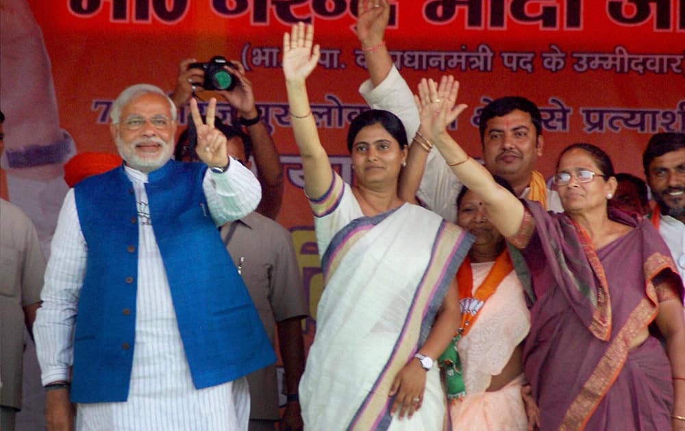 BJP Prime Ministerial candidate Narendra Modi flashes victory sign with Apna Dal President Krishna Patel and party leader Anupriya Patel at an election rally in Mirzapur.