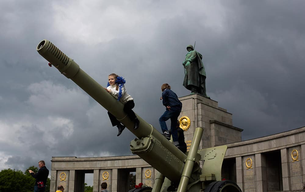 Russian girl Sophia plays with other children on an ordnance during the celebrations of Victory Day at the Soviet war monument and cemetery at the district Tiergarten in Berlin, Germany. Hundreds of Russians attend the celebration in the German capital to mark the victory over Nazi-Germany.