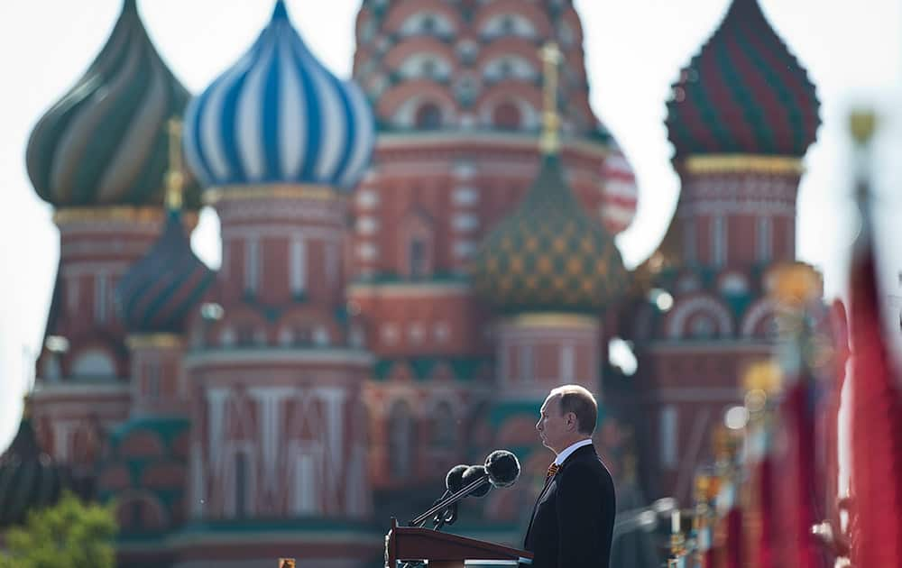 Russian President Vladimir Putin speaks during a Victory Day Parade, which commemorates the 1945 defeat of Nazi Germany, in Red Square, with St. Basil Cathedral in the background, in Moscow, Russia.