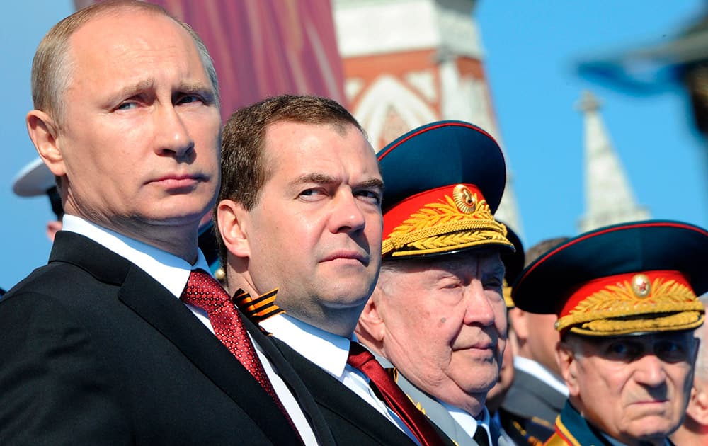 Russian President Vladimir Putin, left, and Prime Minister Dmitry Medvedev attend a Victory Day parade, which commemorates the 1945 defeat of Nazi Germany, at Red Square in Moscow, Russia.