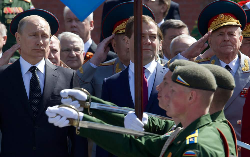 Russian President Vladimir Putin and Prime Minister Dmitry Medvedev, center, take part in the wreath laying ceremony at the Tomb of Unknown Soldier at the Kremlin wall in Moscow. Russia will mark the WWII victory on May 9 holding military parades all over the country including Sevastopol.