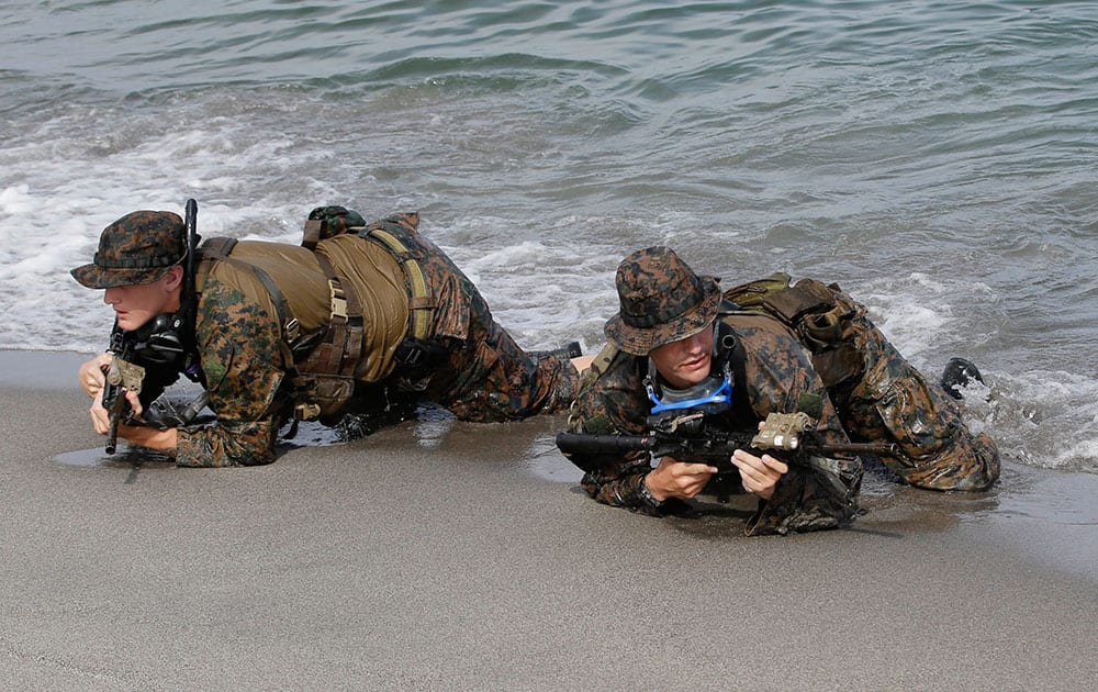 US marines take their position on the shore to simulate a raid with their Philippine counterpart at the joint US-Philippines military exercise dubbed Balikatan 2014 at the Naval Training Exercise Command, a former US naval base, and facing the South China Sea at San Antonio township, Zambales province northwest of Manila.