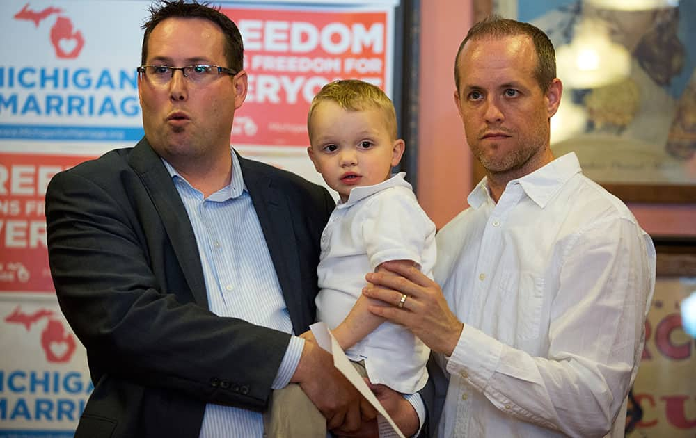 Mike, Declan, and Jacob Hemmingsen tell their family`s story during a news conference in Grand Rapids, Mich..