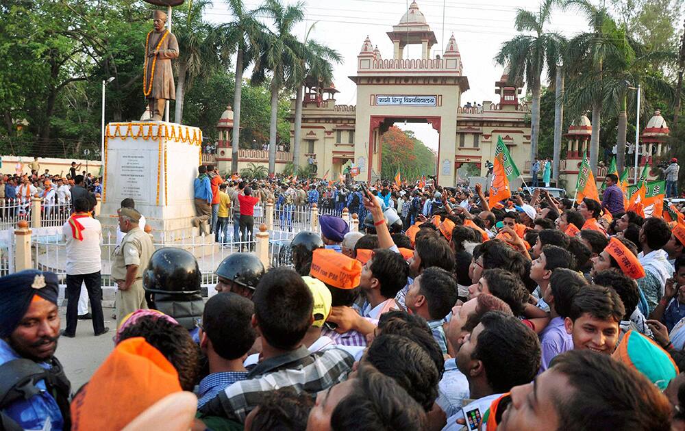 People gather during BJP PM candidate Narendra Modi`s election road show in Varanasi.