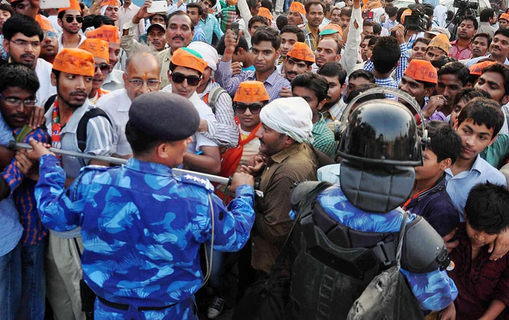 Police control supporters during BJP PM candidate Narendra Modi`s election road show in Varanasi.