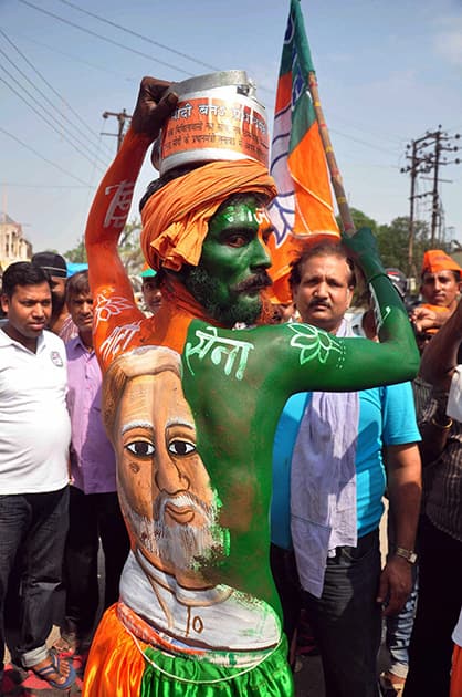 A supporter during BJP PM candidate Narendra Modi`s during an election road show in Varanasi.