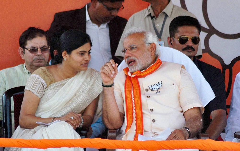 BJP`s PM candidate Narendra Modi and Apna Dal Chief Anupriya Patel at an election campaign rally in Varanasi.