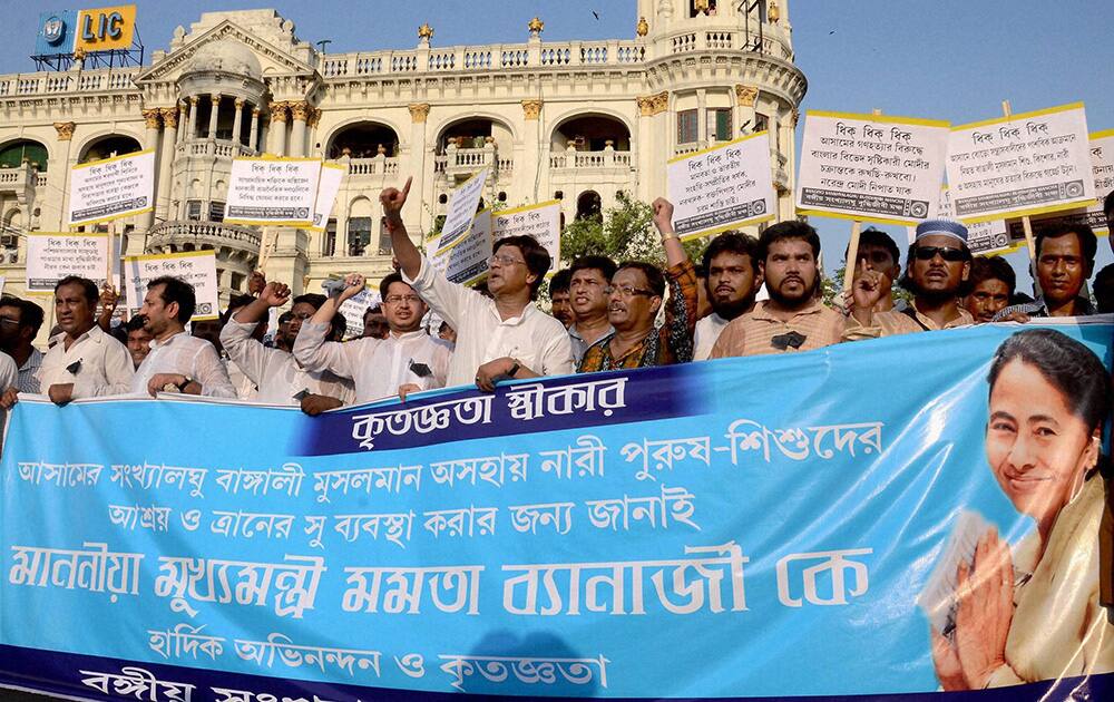 Minority people shout slogans during a protest against the communal violence in Assam, at Esplanade in Kolkata.