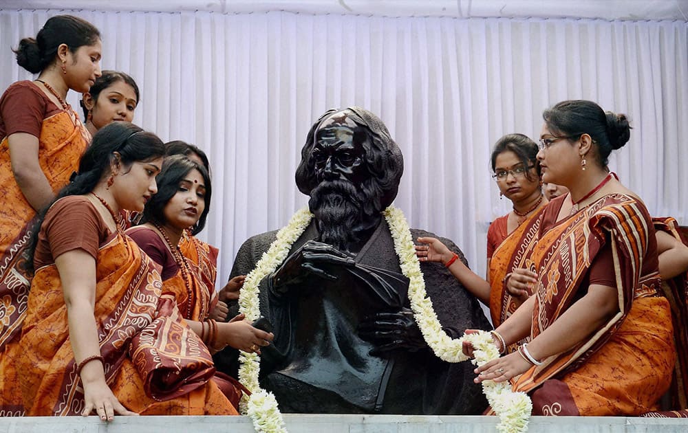 Students of Rabindra Bharati University garland a statue of Nobel Laureate Rabindra Nath Tagore on the poet`s 153rd birth aniversary at his birth place Jorasankho Thakur Bari, in Kolkata.