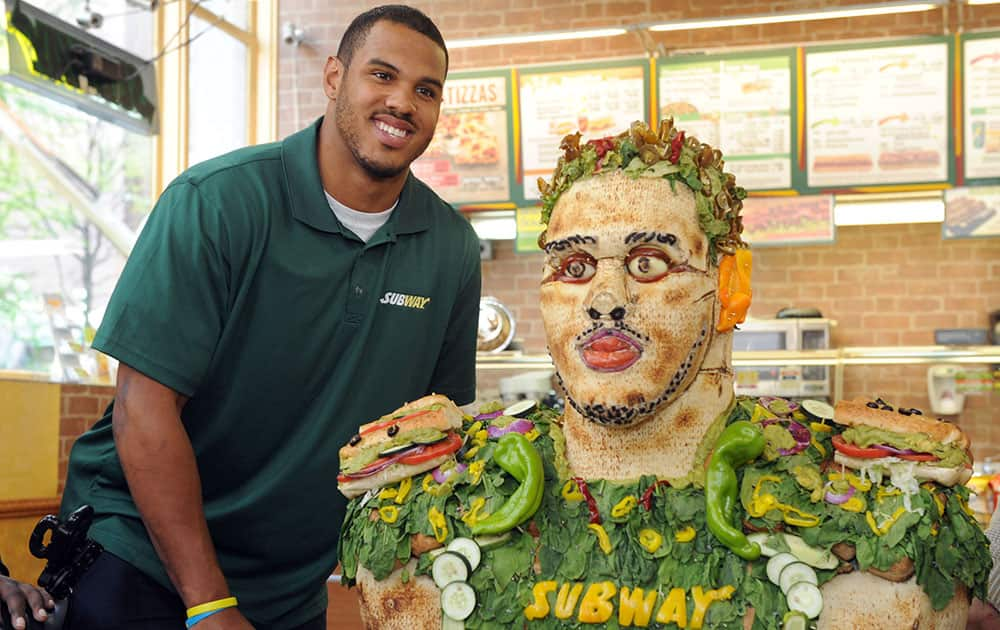 Anthony Barr, 2014 draft prospect and newest SUBWAY Famous Fan, poses with a life-size food statue made of fresh vegetables, in New York. Barr joins a roster of fellow Famous Fans that include Robert Griffin III, Justin Tuck, Russell Westbrook, Pele and Michael Phelps.