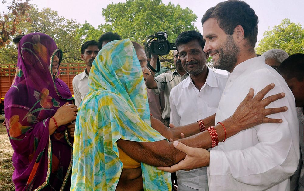 An elderly woman interacts with Rahul Gandhi outside a polling station in Amethi, Uttar Pradesh.