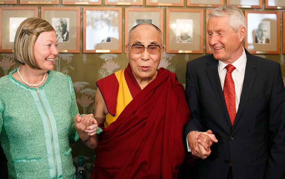 Dalai Lama stands with chairman of the Norwegian Nobel Committee Thorbjorn Jagland, right, and deputy chairwoman Kaci Kullmann Five from the Nobel Peace Prize committee, in Oslo.