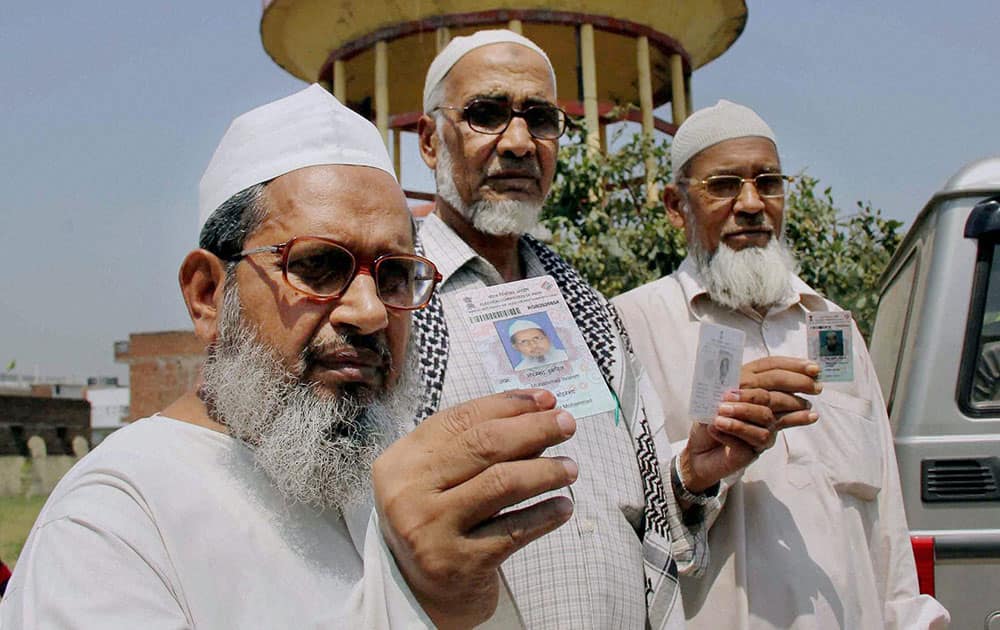 Muslim voters show their inked fingers after casting their votes for Lok Sabha polls at a polling station in Allahabad.