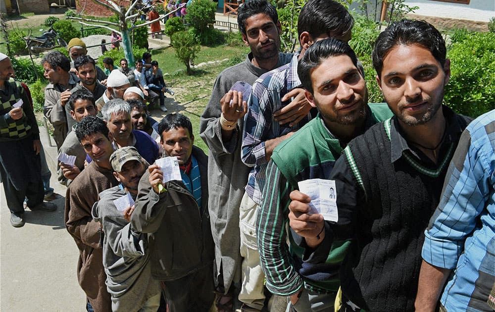 Voters wait to cast their votes for Baramulla constituency at a polling station in Mawar area of Langate in Kupwara district.