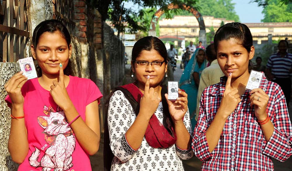 First Time voters showing their ink marked finger after casting vote on 8th phase of Lok Sabha Election in Allahabad.