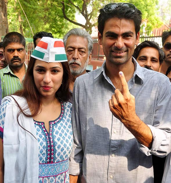 Cricketer and Congress candidate Mohd. Kaif for Phulpur seat with his wife Pooja Yadav shows his ink mark finger after casting vote for 8th phase of Lok Sabha Election in Phulpur.