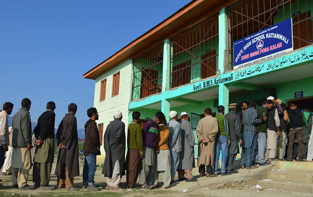 People in a long queue to cast their votes during the 8th phase of Lok Sabha elections,at Katianwali in District Baramulla 65 km`s from Srinagar.
