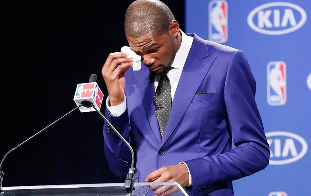 Oklahoma City Thunder`s Kevin Durant wipes away tears as he speaks during a news conference to announce that Durant is the winner of the 2013-14 Kia NBA Basketball Most Value Player Award in Oklahoma City.