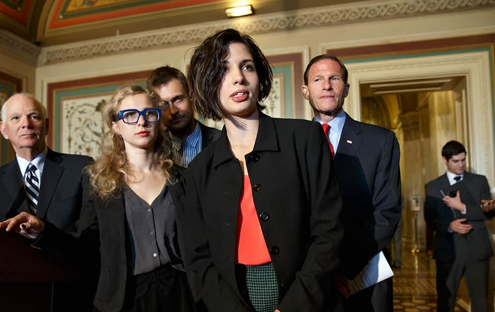 Russian political activists Nadya Tolokonnikova, center, and Maria Alyokhina, center left, of the Russian punk rock protest group Pussy Riot, join Sen. Richard Blumenthal, D-Conn., right, and Sen. Ben Cardin, D-Md., far left, the chairman of the Helsinki Commission, in seeking action to stop violations of human rights by pro-Russian militants in the Ukraine region, at the Capitol in Washington.