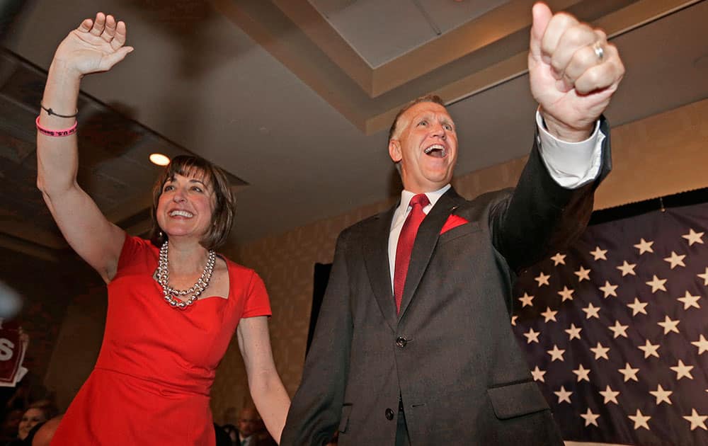 Thom Tillis, right, and his wife Susan Tillis, left, greet supporters at a election night rally in Charlotte, N.C., after winning the Republican nomination for the US Senate.