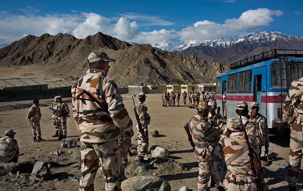 Indian security forces gather at a voting machine distribution center on the eve of the eighth phase of voting of the Indian parliamentary elections in Leh.