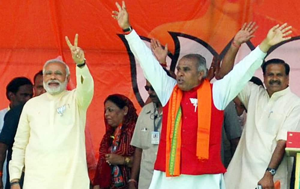 BJP PM candidate Narendra Modi with party candidate Jagdambika Pal during an election campaign rally in Sidharth Nagar.