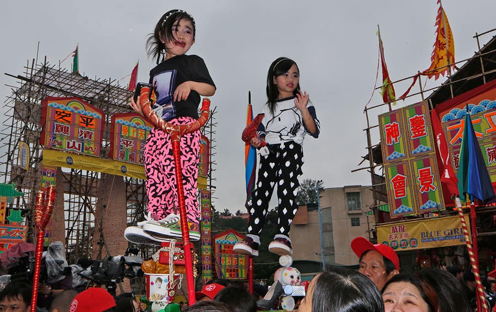 A young performer cries as she parades during the Bun Festival on Cheung Chau island in Hong Kong.