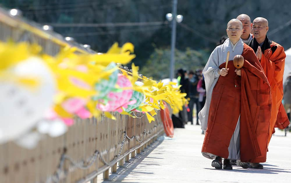 Monks march during a Buddhist ceremony for cherishing the memory of the deceased and the missing passengers of the sunken ferry Sewol, at a port in Jindo, south of Seoul, South Korea.