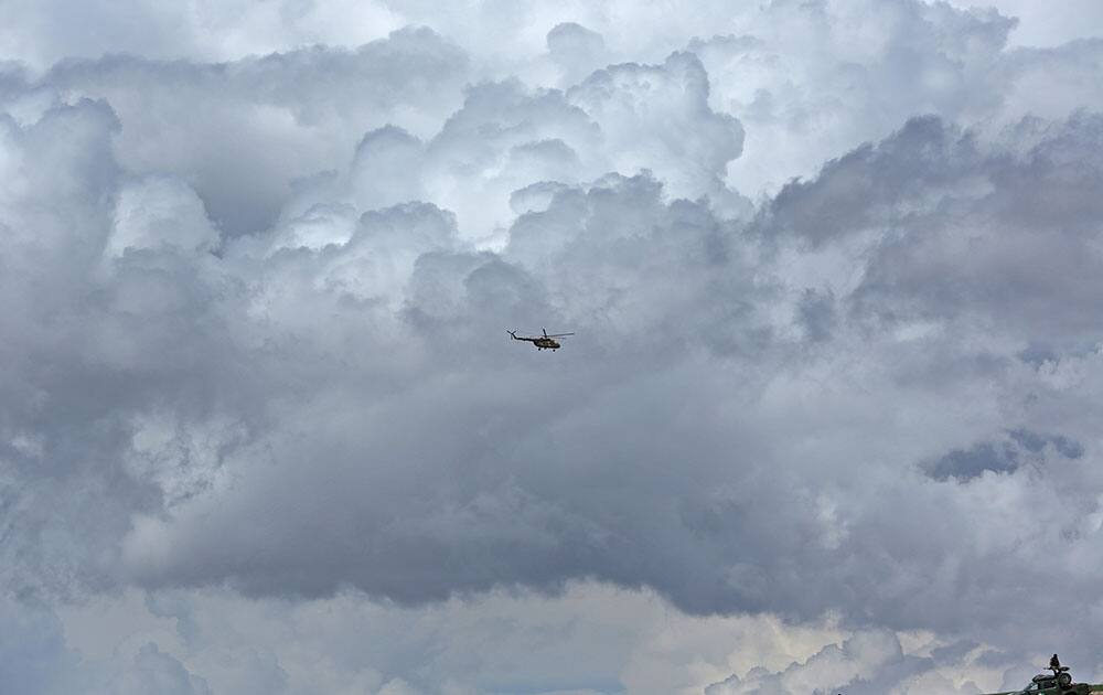 An Afghan National Army helicopter flies over the site of Friday`s landslide that buried part of Abi Barik village in Badakhshan province, northeastern Afghanistan.