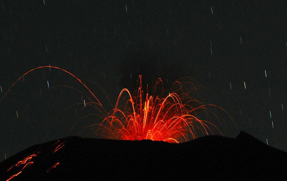 In this photo taken with slow shutter speed, Mount Slamet spews hot lava from its crater as seen from Paguyangan, Central Java, Indonesia.