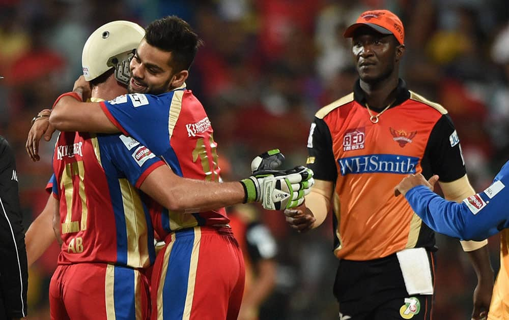 Royal Challengers Batsman AB De Villiers with Virat Kohli celebrates after hitting the winning run during the IPL 7 Match against Sunrisers Hyderabad at Chinnaswamy Stadium in Bengaluru.