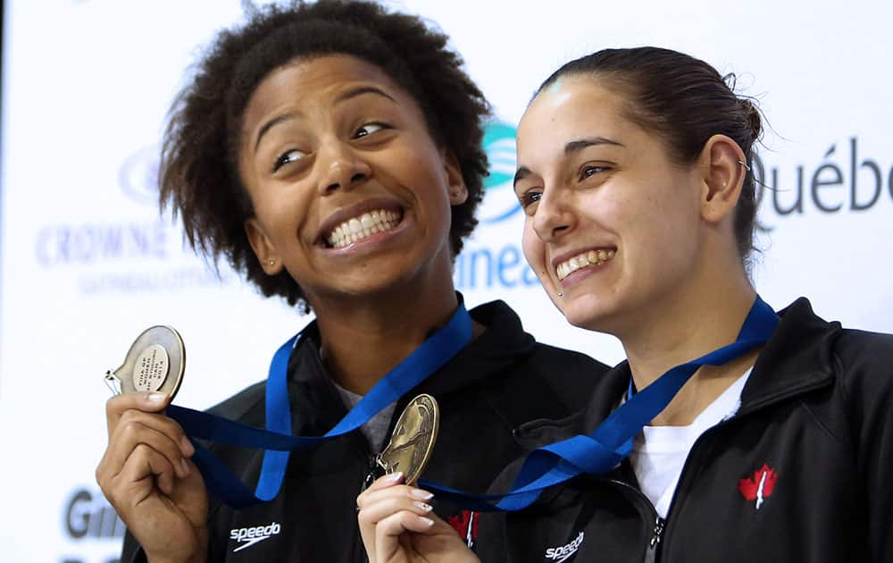 Canada`s Jennifer Abel, left, and Pamela Ware display their gold medals after winning the Women`s open three-metre synchro at the Canada Cup Grand Prix diving competition in Gatineau, Quebec.