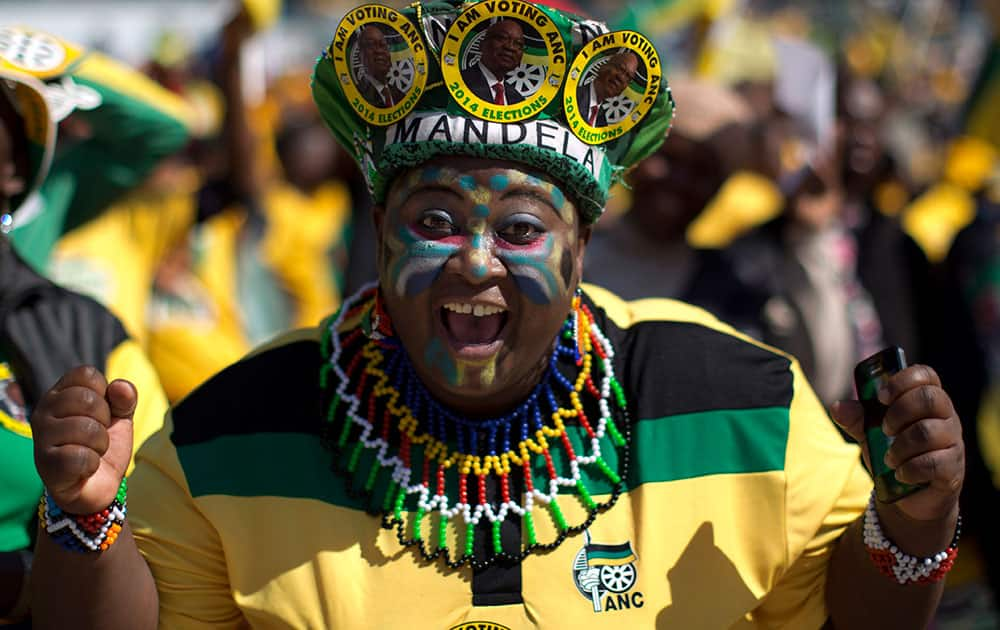 A woman sporting headgear with portraits of South African president Jacob Zuma attends a final African National Congress (ANC) election rally in Soweto, on the edge of Johannesburg.