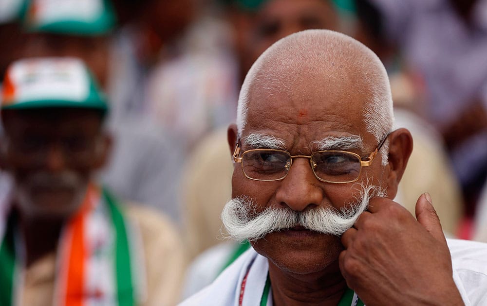 A Congress party supporter listens to Vice President Rahul Gandhi address an election campaign in Amethi, in the northern Indian state of Uttar Pradesh.