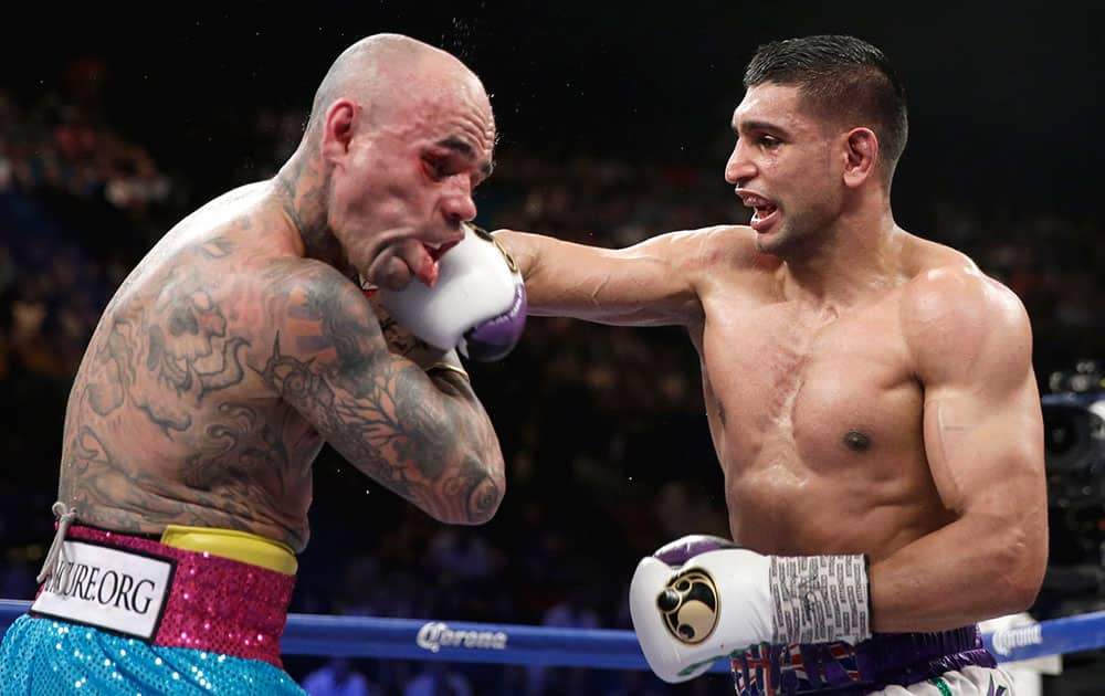 England`s Amir Khan, right, connects with a hard right to the head of Luis Collazo in their silver welterweight title boxing fight, in Las Vegas.