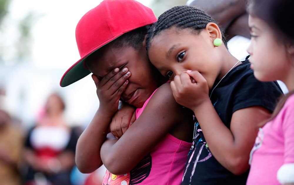 Children cry during a prayer vigil for Martin Cobb. A 16-year-old boy was charged Saturday in the assault of a young girl and the killing of her 8-year-old brother, Martin, who was apparently slain when he tried to protect her, authorities and relatives said. 