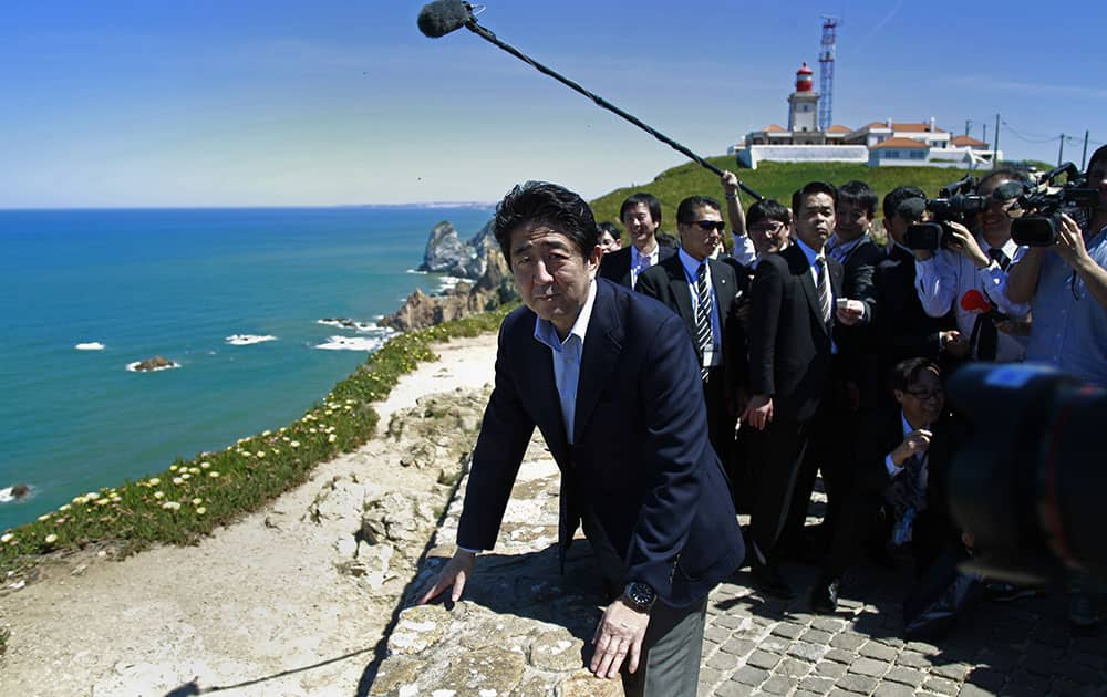 Japan`s Prime Minister Shinzo Abe looks from a viewpoint over the sea during a visit to Roca Cape, the westernmost point of the continental Europe, near Sintra, Portugal.