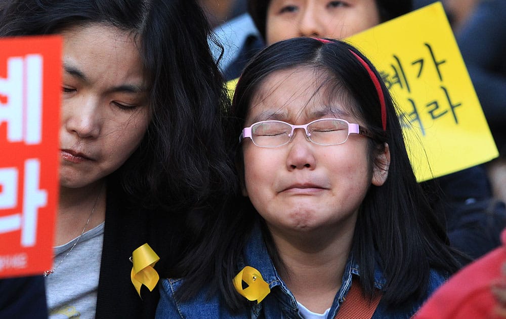 A girl cries during a rally to pay tribute to the victims of the sunken ferry Sewol, in Seoul, South Korea.