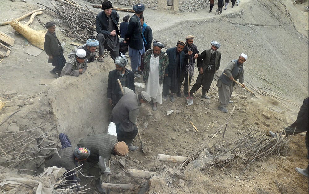 Afghans search for survivors buried after Friday`s landslide in Abi-Barik village in Badakhshan province, northeastern Afghanistan.