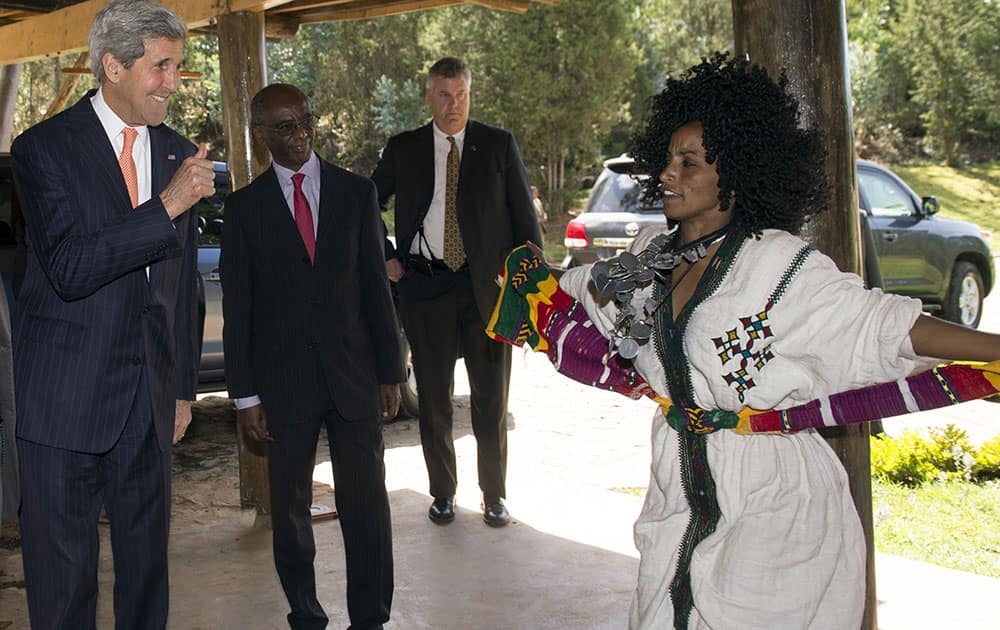 US Secretary of State John Kerry gives a thumbs-up to a local dancer prior to speaking about US policy in Africa at the Gullele Botanic Garden in Addis Ababa, Ethiopia.