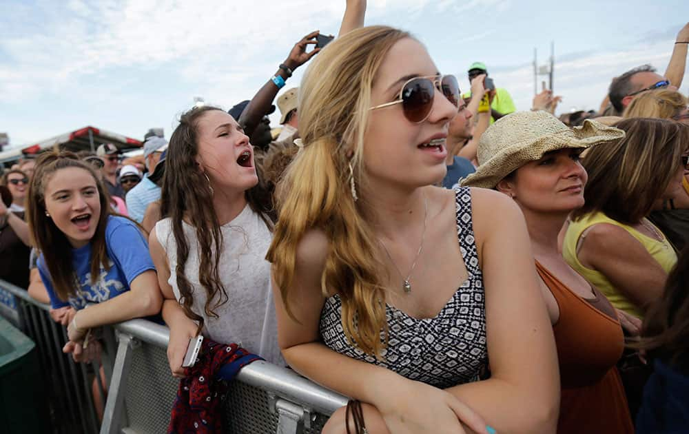 Fans cheer as Christina Aguilera performs at the New Orleans Jazz and Heritage Festival in New Orleans.