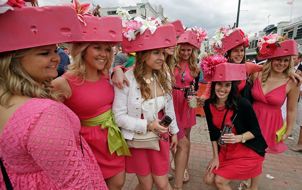 Women pose for a photo in the paddock before the 140th running of the Kentucky Oaks horse race at Churchill Downs, in Louisville, Ky.