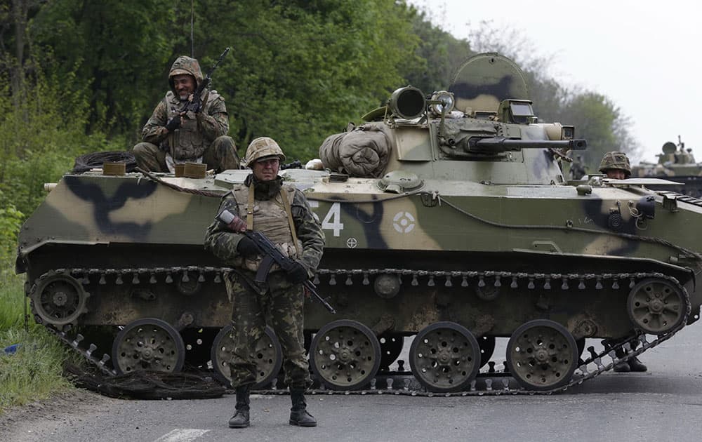 Ukrainian soldiers stand guard on a road leading to Slovyansk, eastern Ukraine.