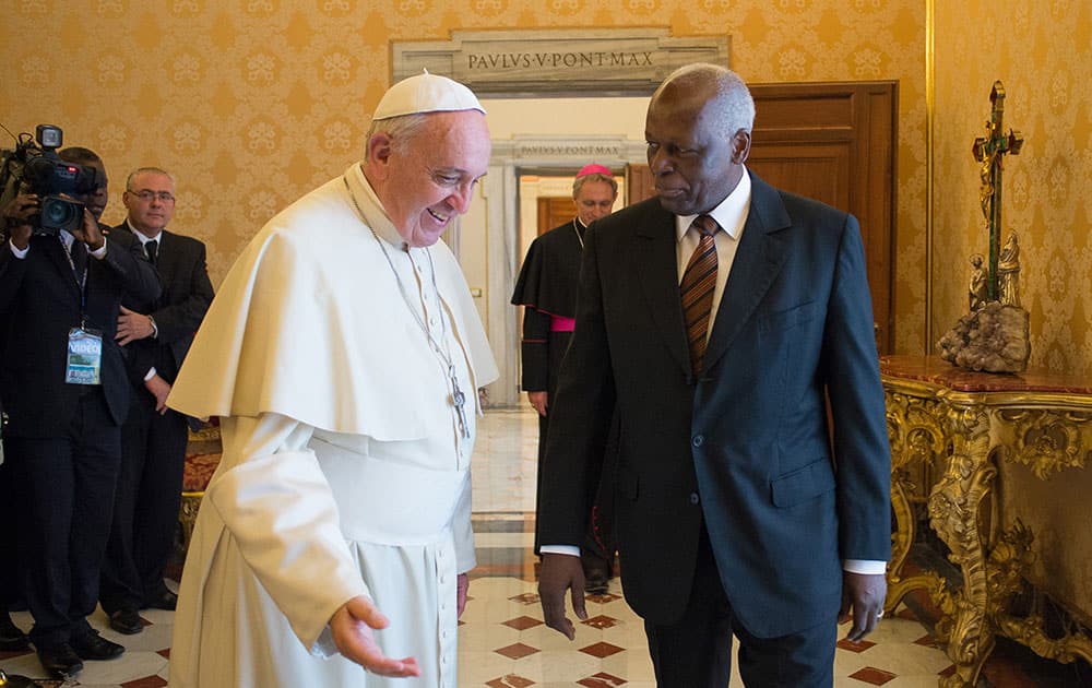 This photo provided by the Vatican newspaper L`Osservatore Romano, Pope Francis exchanges gifts with Angola`s President Angola Jose Eduardo Dos Santos, during a private meeting at the Vatican.